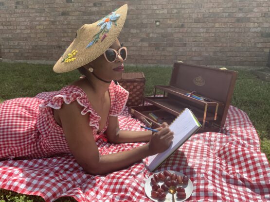 IMG 0544 A woman on a picnic blanket in vintage hat and dress