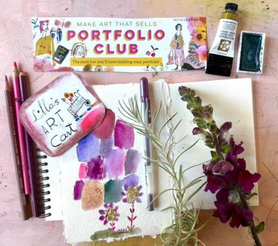 portfolio club Lilla's art carts, sketchbook and art supplies on a desktop