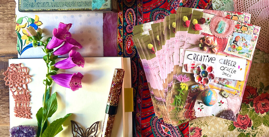 Manifest your dream creative career with Lilla's oracle cards and flowers on a desk