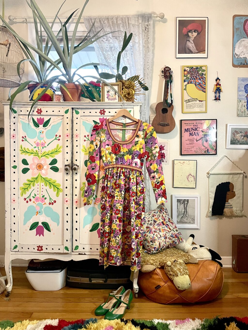 Tamisha's vintage collectionimage 50765825 a patterned dress hanging up in front of a wardrobe in a room of vintage pictures and items